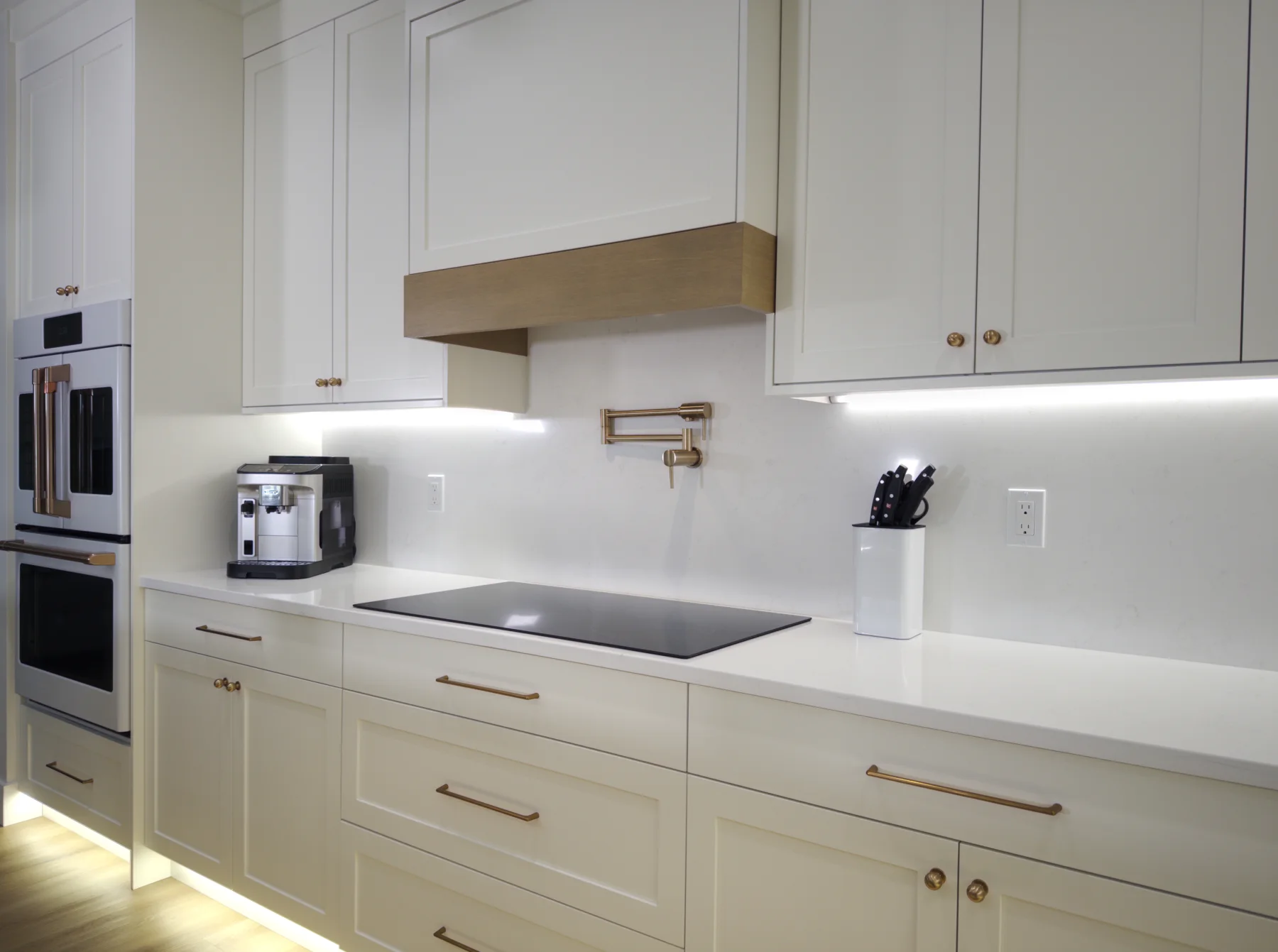 Finished cooktop wall with quartz countertop and full-height slab backsplash