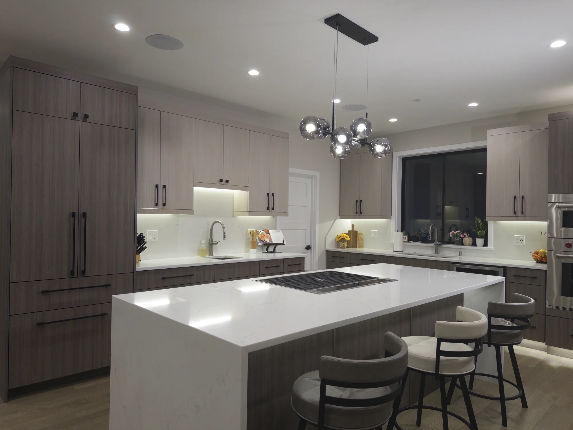 Completed Bellingham kitchen with polished quartz countertops and a waterfall island
