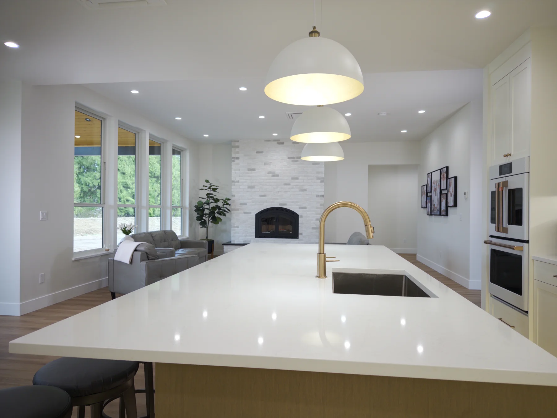 Lengthwise view across the oversized quartz island toward the living area