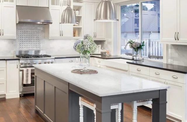 White quartz countertops installed in a bright kitchen with an island