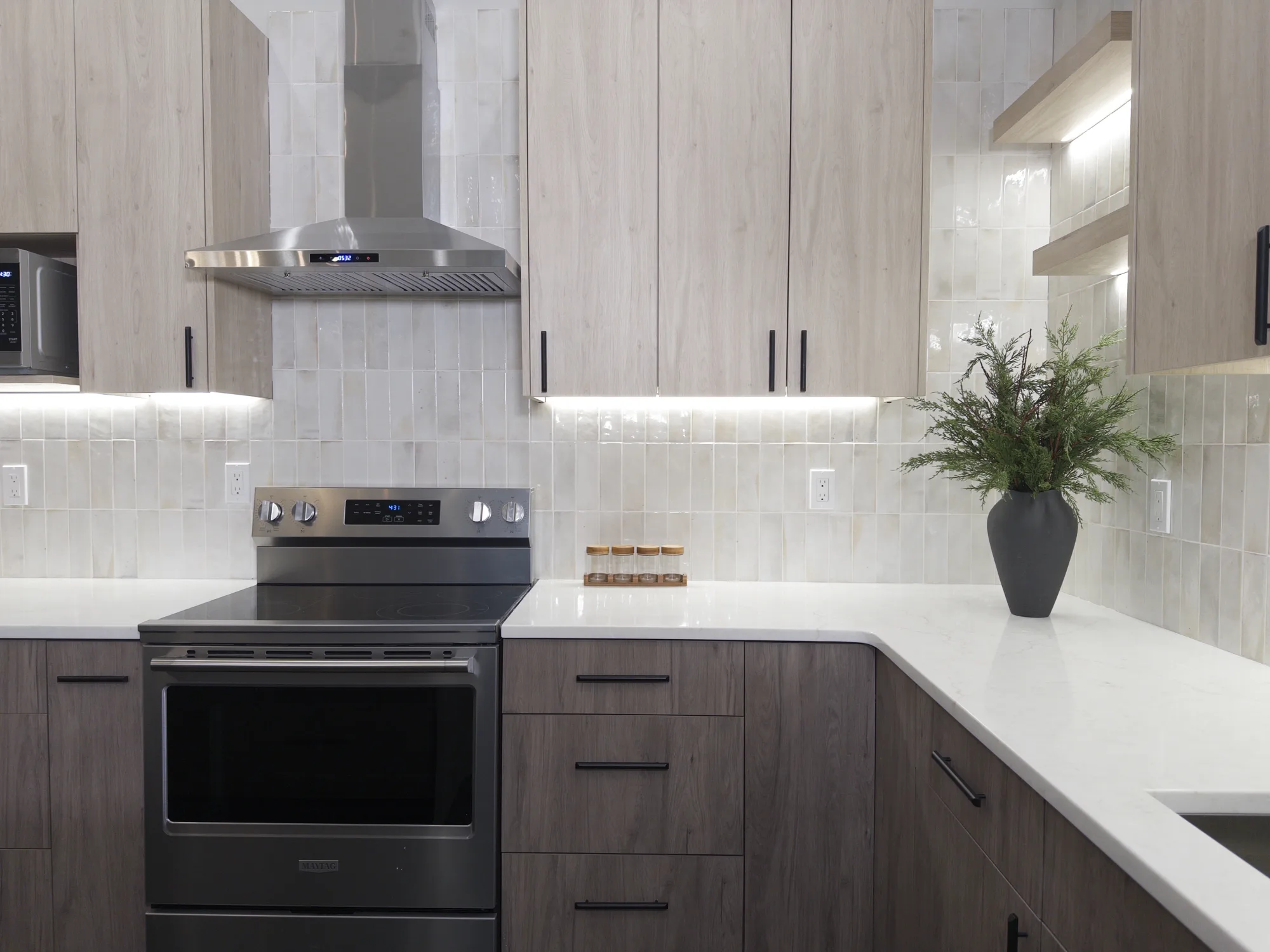 Quartz perimeter countertop beside the range in the secondary kitchen